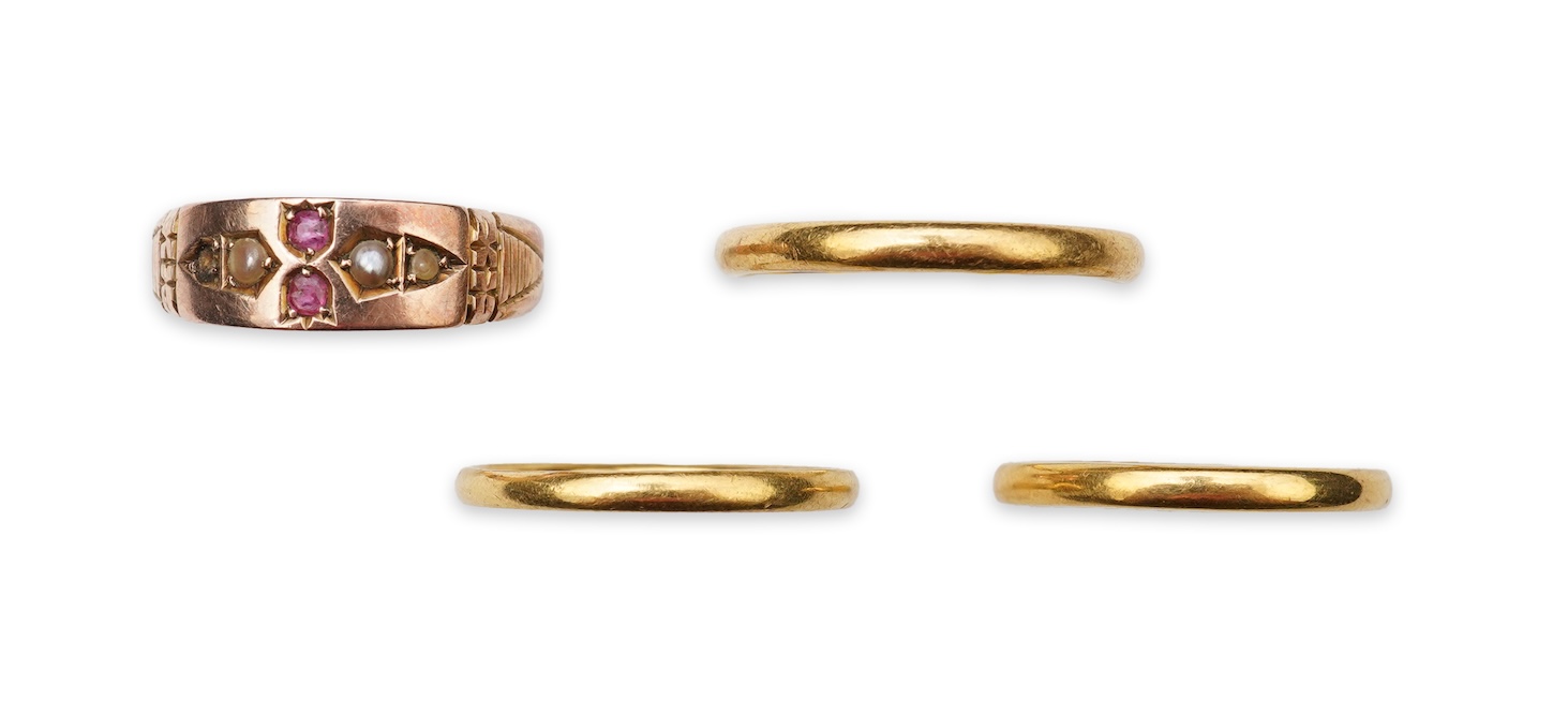 A collection of four gold rings